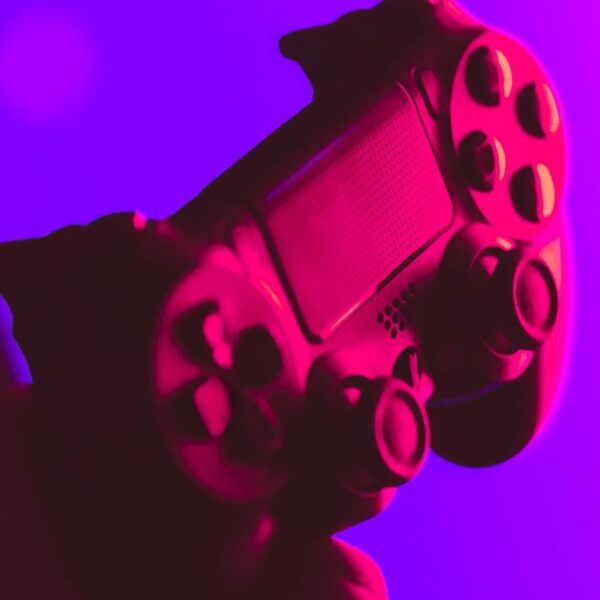 A game controller bathed in neon light